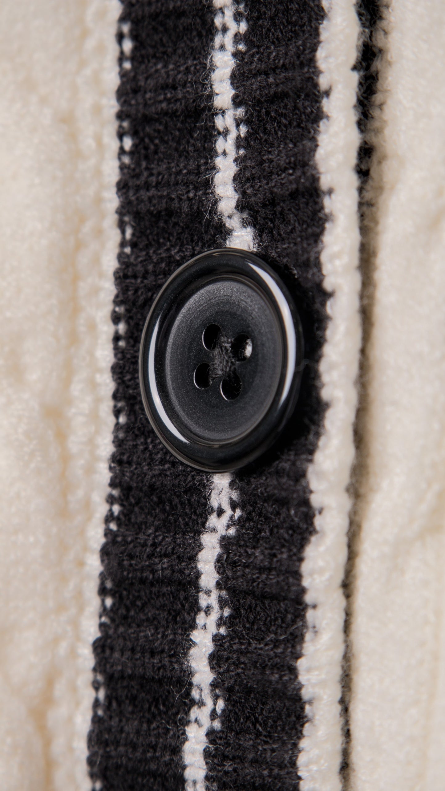 KNITTED SWEATER WITH EMBOSSED BUTTONS AND V-NECK